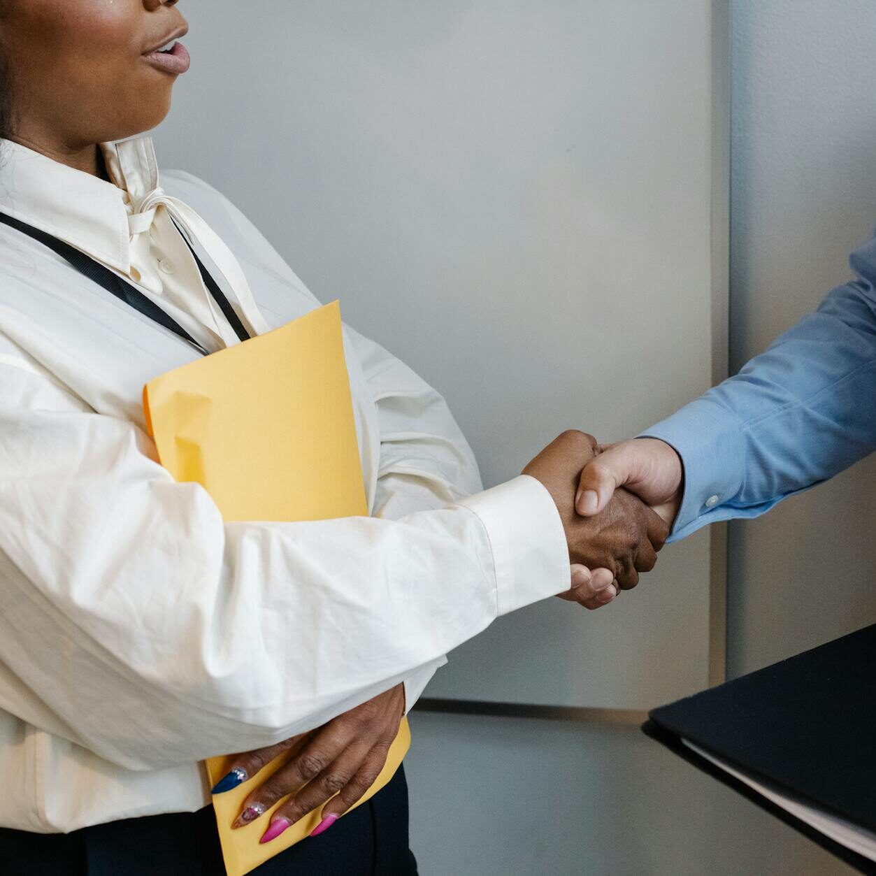 diverse coworkers shaking hands after meeting