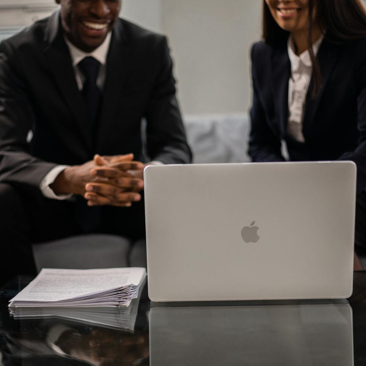 a close up shot of a man and a woman using a laptop