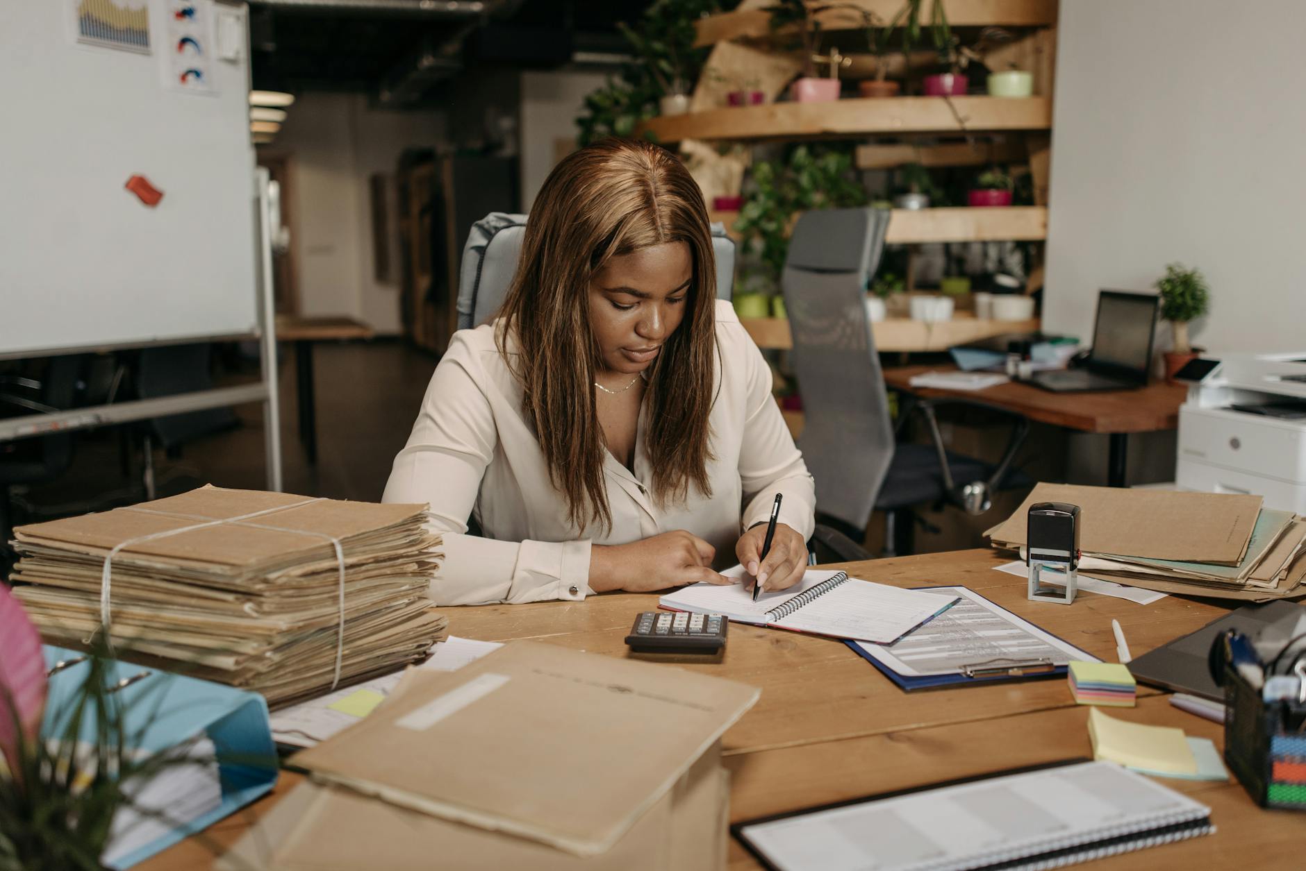 a woman writing on a notebook