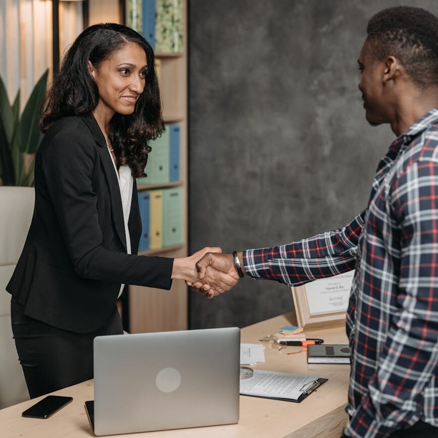 a woman handshake with the client