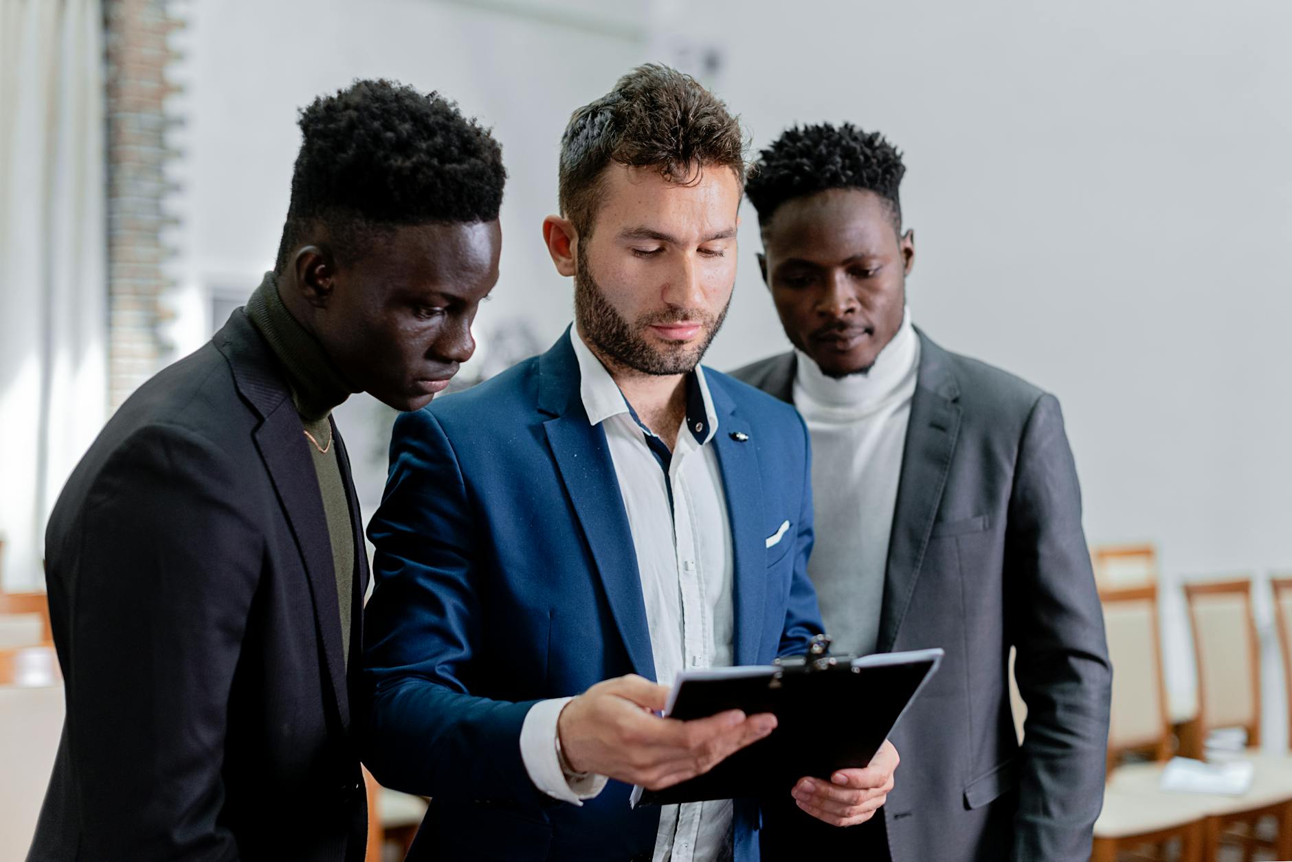 three men looking the document together